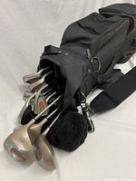 Set of women's Pro Select golf clubs in black Mizuno golf bag, showing several clubs with protective headcovers and tool attached to bag.