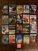 Photo of 20 DVD cases arranged in a grid on wooden floor, showing front covers with titles and artwork.