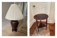 Photo shows table lamp with dark ceramic base and white pleated shade alongside the folding leaf side table with folded round top and four legs.