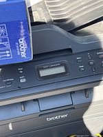 Close-up of the Brother DCP-L2540DW printer control panel with display and buttons