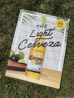 Full view of the Corona Light tin sign showcasing the design, text, and branding.