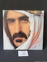 Front cover of signed Frank Zappa vinyl album showing close-up portrait with signature.