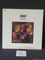 Front cover of Spirit vinyl album showing the band photo and album title on a white background, with visible cover damage at the bottom.