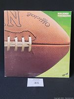 Front cover of Bob James Touchdown vinyl record showing close-up football with signatures, album title on top right corner.