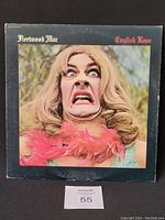 Front cover of Fleetwood Mac 'English Rose' vinyl record, showing a close-up image of a person with blonde hair and a pink feather boa.