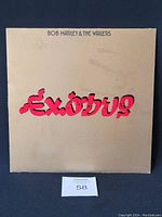 Front album cover, beige with red "Exodus" lettering and artist name in black.