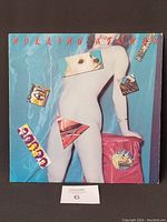 Front cover of the Rolling Stones vinyl record showing the nude figure artwork with placed images.