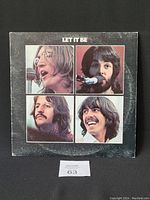 Front cover of The Beatles "Let It Be" vinyl LP album showing portraits of the four band members.