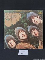 Front cover of the Rubber Soul vinyl record album by The Beatles showing the band members' faces against a green background.