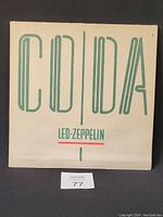 Front cover of Led Zeppelin's vinyl record "Coda" showing the album title in large stylized green text on white background, and the band's name below it.