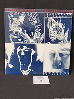 Front cover of The Rolling Stones Emotional Rescue vinyl album showing artistic blue and white portrait images.