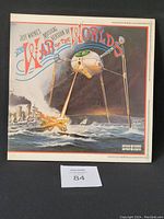 Front of the vinyl record cover showing the mechanical tripod attacking a ship on the water.