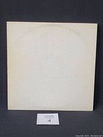 Front cover of The Beatles White Album gatefold showing embossed lettering and discoloration.