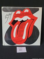 Front cover of vinyl album showing Rolling Stones tongue logo with album title and track listing