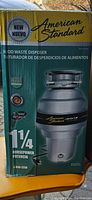 Box front showing American Standard food waste disposer image and 1 1/4 horsepower labeling.