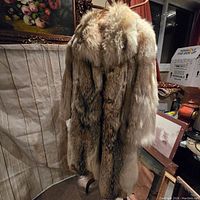 Full view of the vintage fur coat showing the multi-tone natural fur with long soft texture.