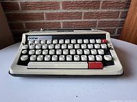 Front view of the Brother Activator 850TR typewriter showing the keys and body in beige and black with red accents.