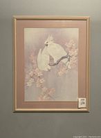 Front view of the framed print showing two white cockatoos on a branch with pink blossoms.