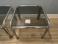 Photo of right side table showing smoked glass top and chrome tubular frame