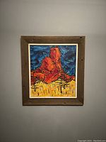 Full view of the framed abstract oil painting on board hung on a wall