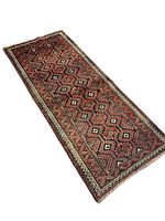 Full view of handmade Baluchi rug showing geometric pattern in black and red hues with bordered edges and fringed ends.