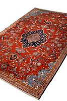 Angled top view showing red field with central navy medallion and floral border.