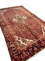 Angled full-view shot of rug showing overall pattern and pile wear