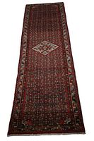 Full view of the dark red Persian Hamadan Hossein Abad style runner rug with borders and central medallion.