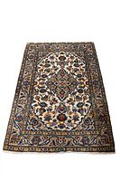 Full view of Persian Kashan rug showing overall medallion and floral pattern on white background.