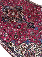 Central field and medallion of the red and black floral rug