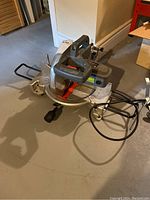 Side view of the Concept CMS10HD compound mitre saw showing handle, power cord, and base.