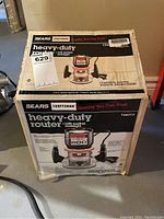 Photo of the Craftsman Sears Heavy-Duty Router in its original box, showing front and side details including model number and features.