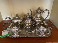 Full view of the entire silver plate tea and coffee set on the serving tray showing all pieces.