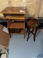 View of both small wooden end tables showing one with removable tray top and another with shelves and decorative side slats