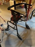 Nexus walker angled view showing front wheel, frame, and handlebars with brake lever.