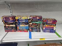 Lot of 38 anime VHS tapes stacked on shelving.