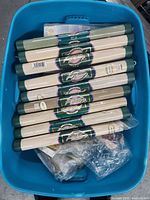 Top view of fabric rolls inside blue tote storage container