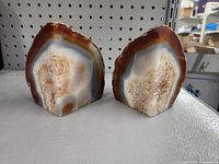 Single geode stone bookend showing polished face with brown, white, and gray bands and crystalline center.