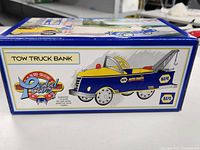 Side of box showing die-cast model tow truck bank with NAPA branding.