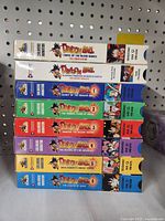 Front view showing the spines of 8 Dragon Ball VHS tape cases in original sleeves, displaying titles and artwork.