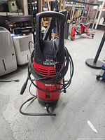 Front and top view of the Husky 1650 PSI power washer showing the unit, handle, and coiled hose.