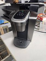 Front angled view of Keurig coffee maker showing basic shape, color and drip tray