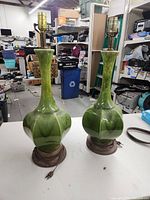 Pair of vintage green ceramic lamps with wooden bases, showing overall shape and cords