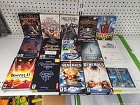Flat display of 18 PC game boxes showing titles and cover art for various strategy, RPG, simulation, and action games.