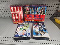Front view of 14 Tenchi Muyo! VHS tapes including series and two movies with anime artwork on covers