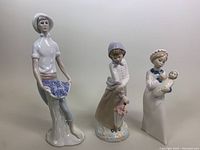 Photo of front view of the 3 porcelain figurines showing their details and colors