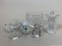 All items displayed together on neutral surface showing all included crystal and glass figurines, vase, and bowl.