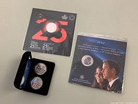Photo of Toronto Raptors 25th Season coin and 2011 Royal Wedding coins in original packaging.