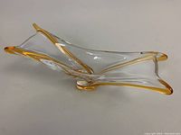 Side view showing the smooth flowing freeform shape with amber edging.