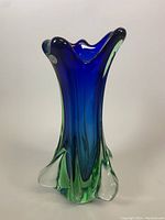 Front angled view showing blue and green Sommerso layers, scalloped top and foot